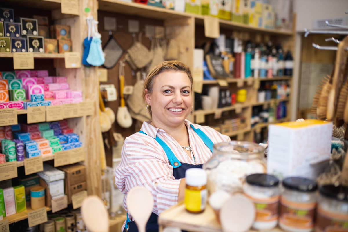 A friendly staff member stocking the shelf