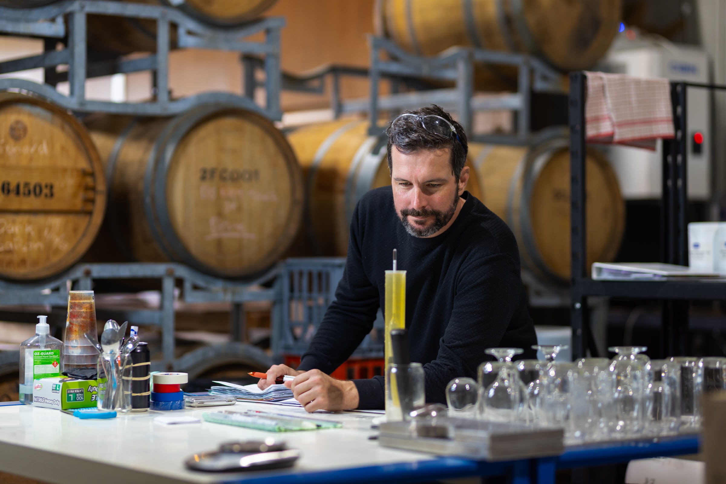 Image of Ryan White, founder of Someday Somehow, looking at their product. 