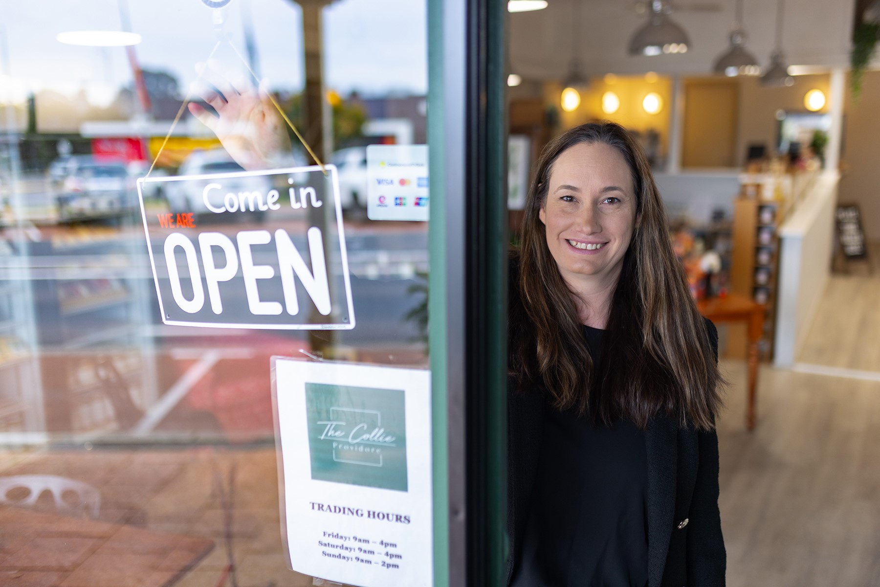 Photo of Rom Blount standing at the entrance of her business, The Collie Providore.