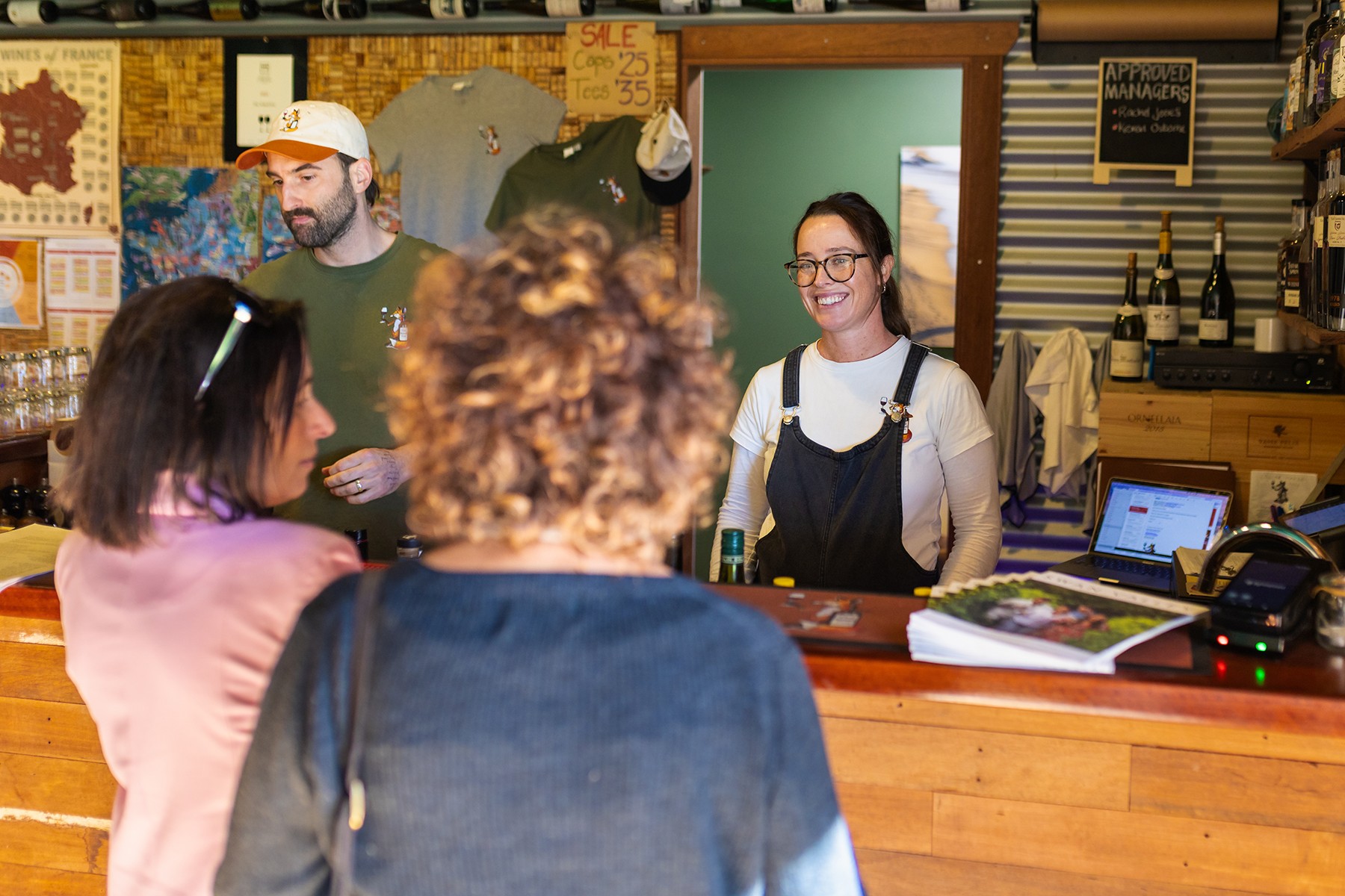 Photo of Keven Osborne and Rachel Jones behind the bar and serving customers.