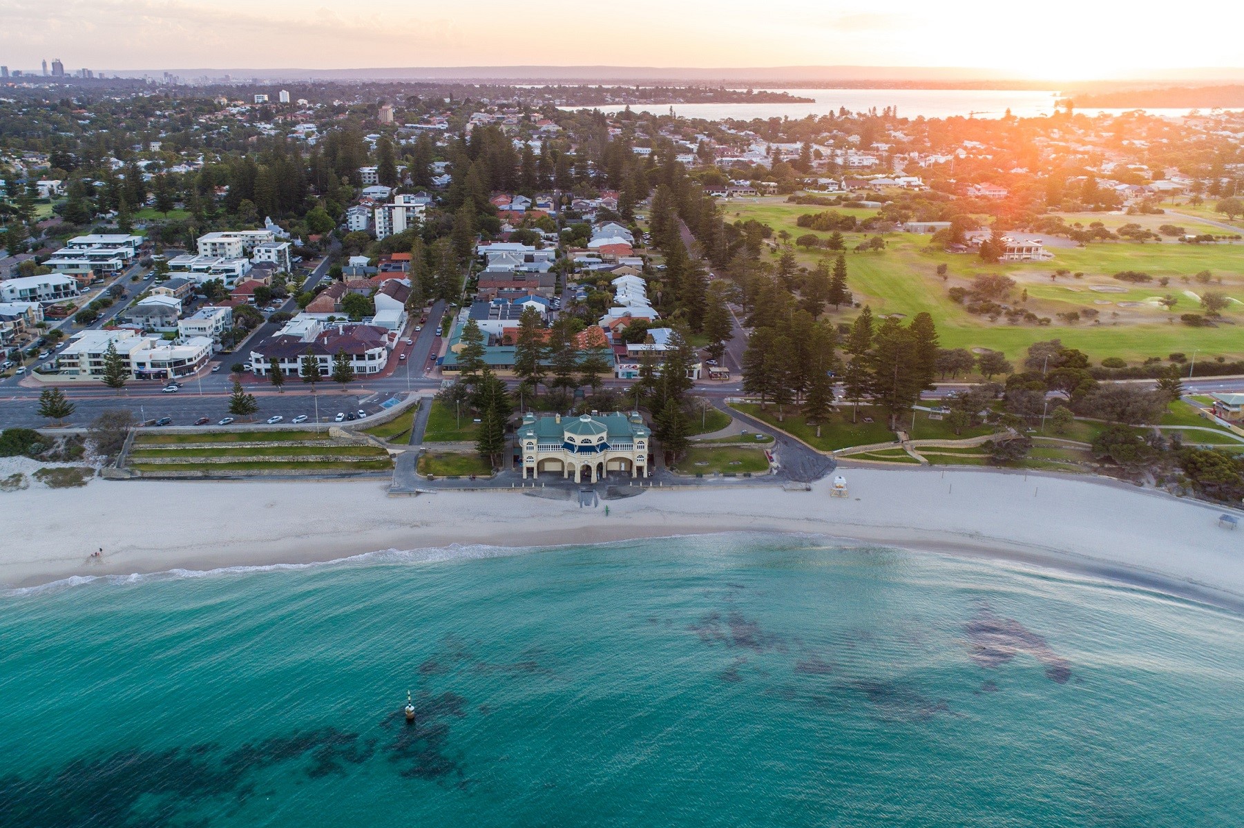 Aerial photo of Cottesloe beach with the Swan River in the background.