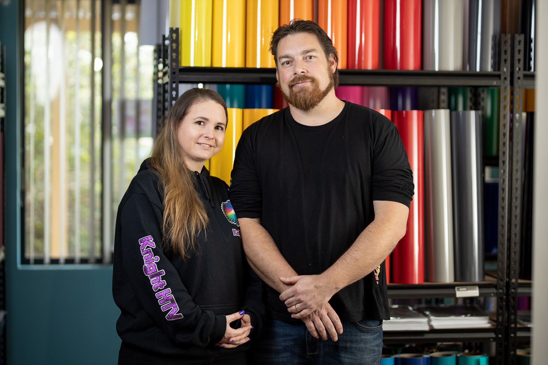 Photo of a male and female business partner standing in their business premises.