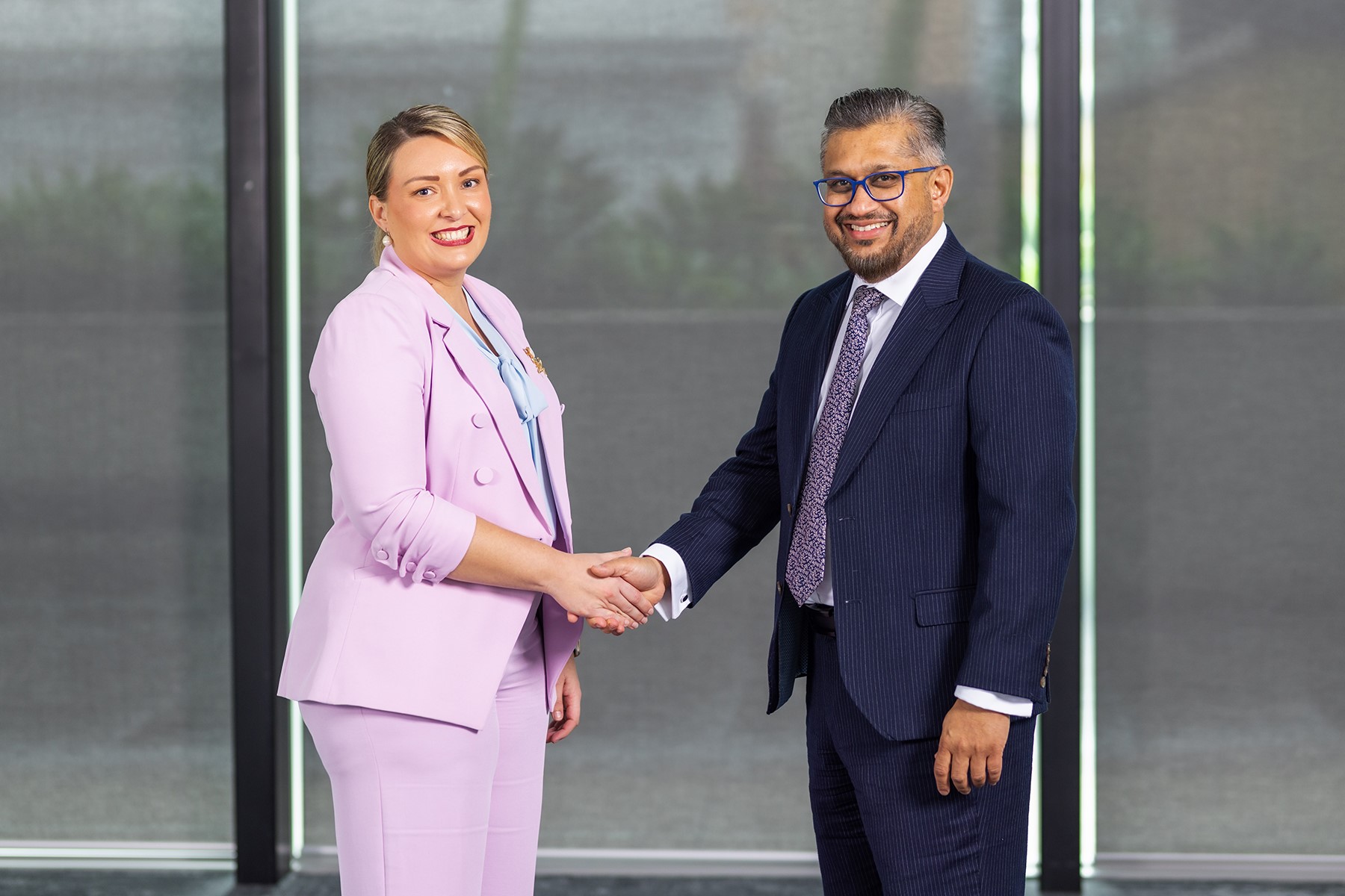 SBDC Board Chair Sharni Foulkes shaking hands with Small Business Commissioner and SBDC CEO Saj Abdoolakhan.