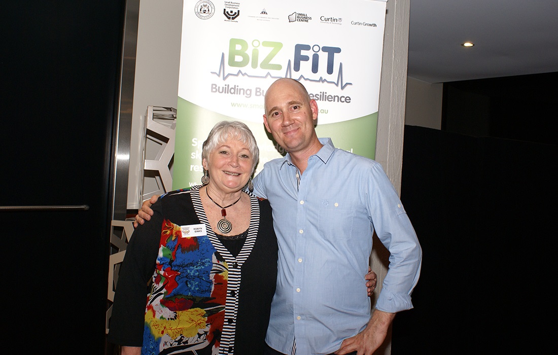 Photo of SBDC staff members standing in front of a BizFit banner.