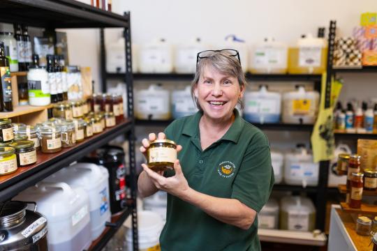 Photo of Claire Sly holding a product in her business, Nanna's Pantry.