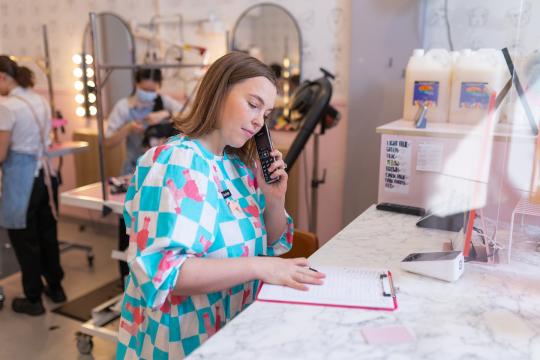 Female business owner talking on the phone 