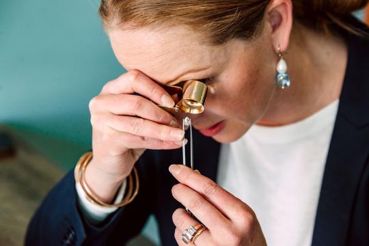 Image showing jeweller looking at diamond.