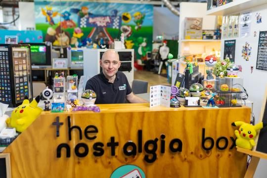 David Green, owner of The Nostalgia Box, sitting at the counter of his business The Nostalgia Box.