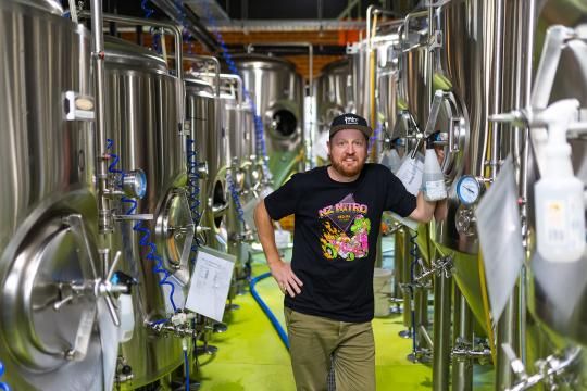 Man standing in a brewing facility.