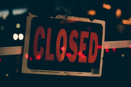 Photo shows a closed sign on a door 