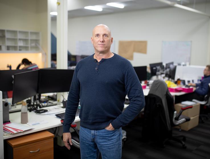 Photo of a man standing in an office.