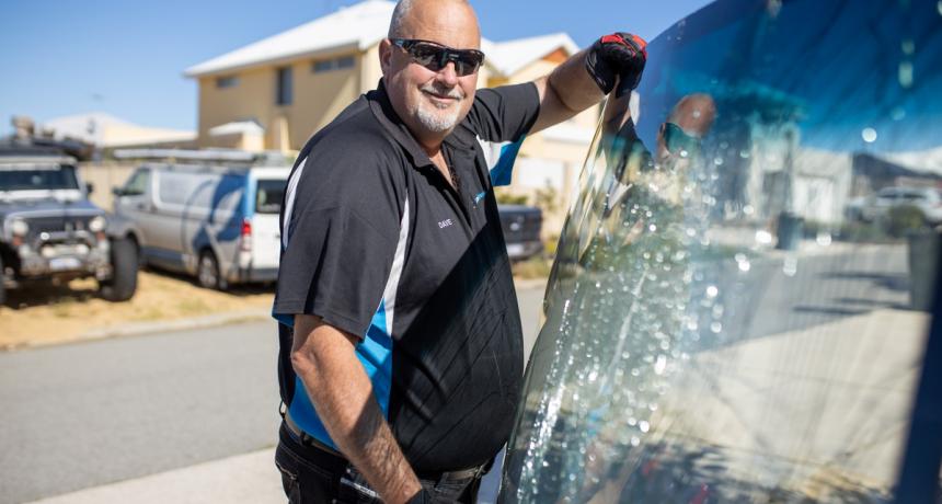 Man holding a broken pane of glass