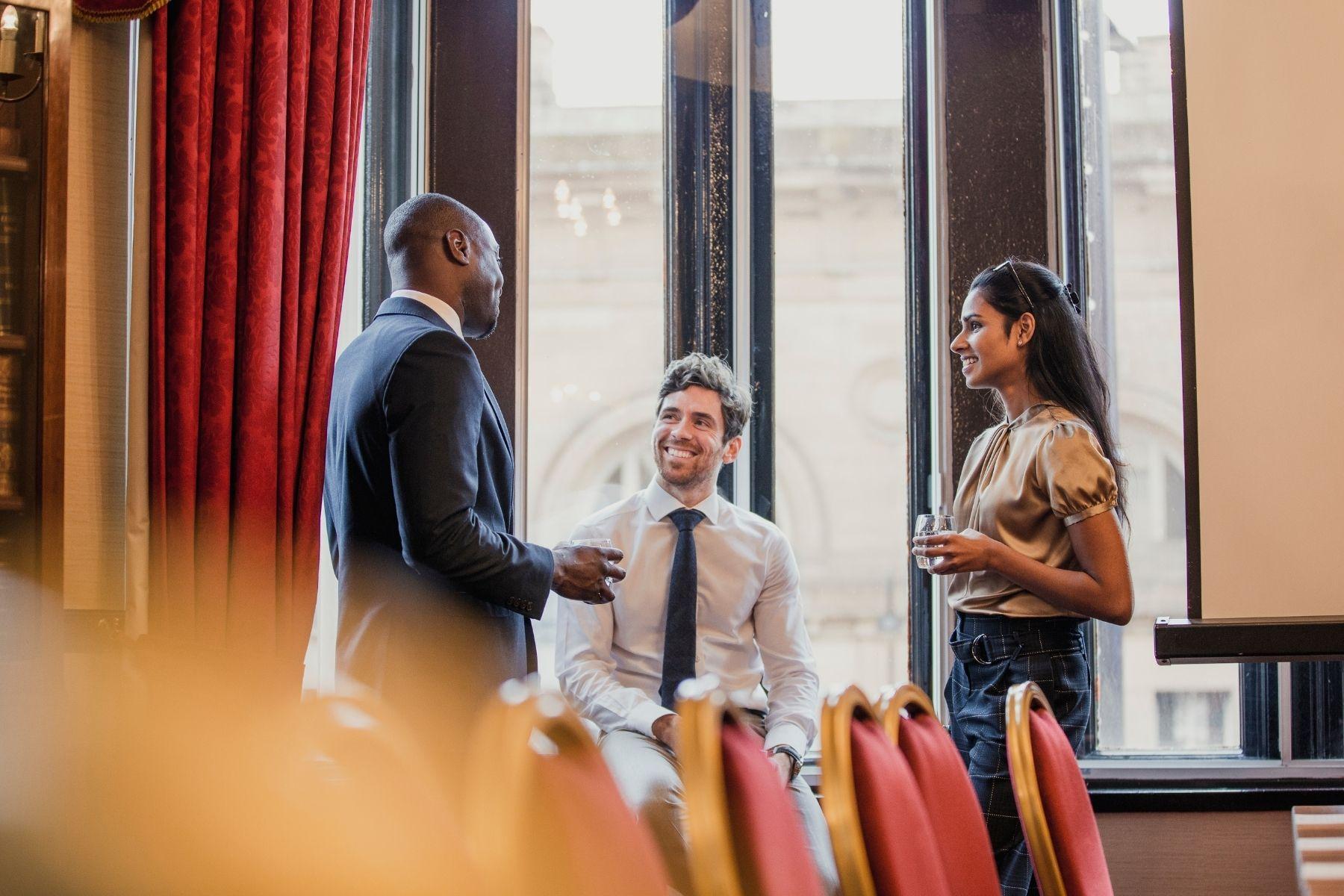 Photo of men and women at a business networking event for professionals.