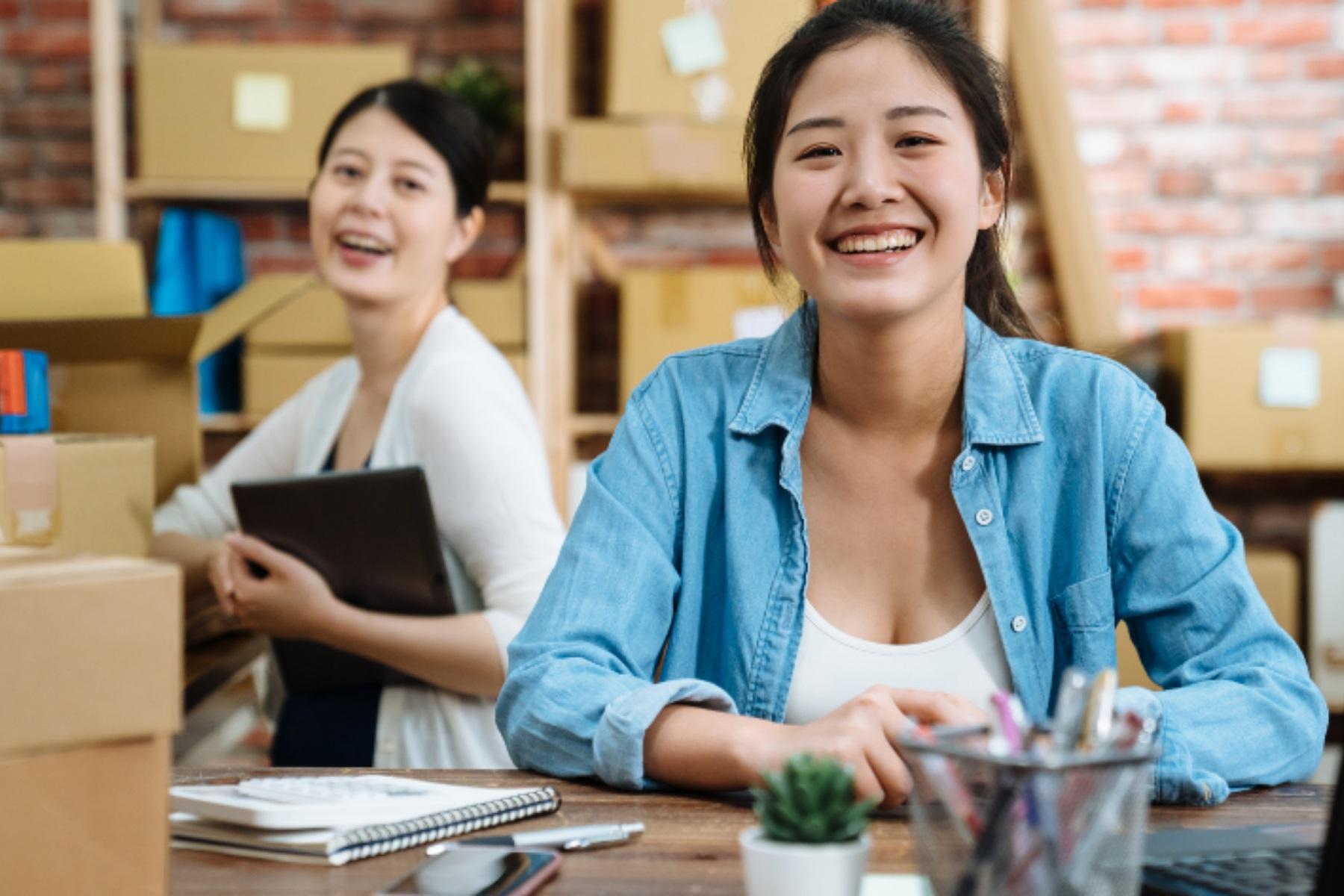 Photo of two women working in a warehouse.