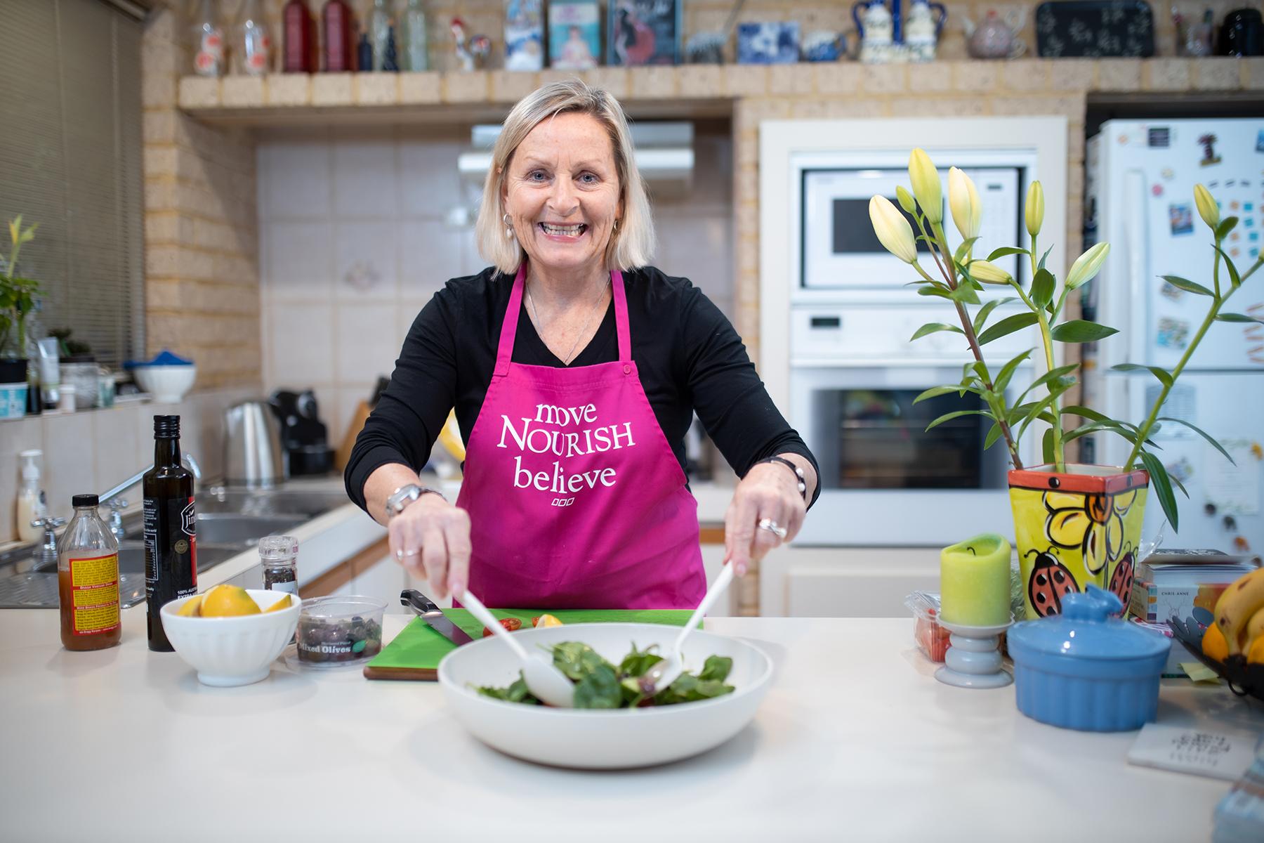 Photo of Fiona Taylor preparing food in her kitchen.