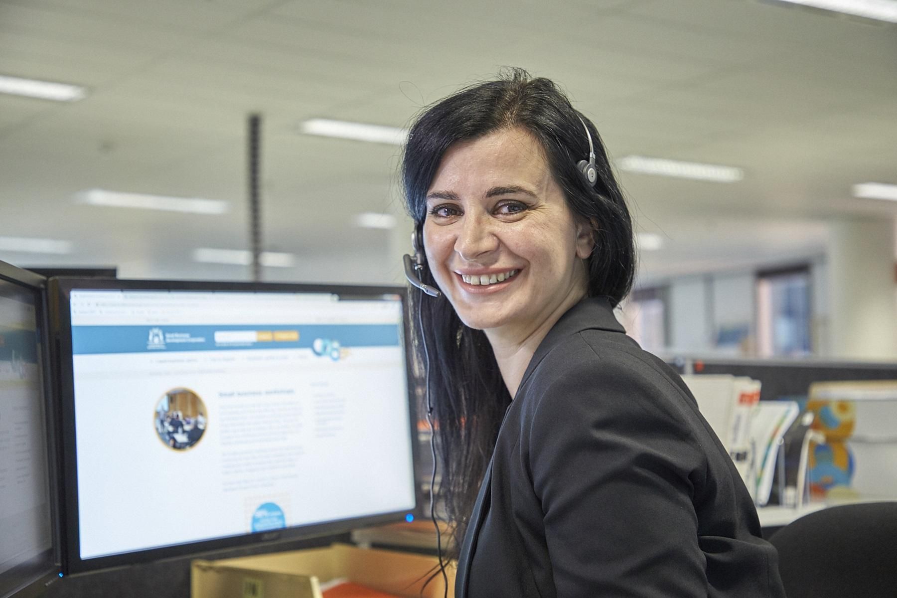 Photo of an SBDC business adviser providing guidance to a client over the phone.