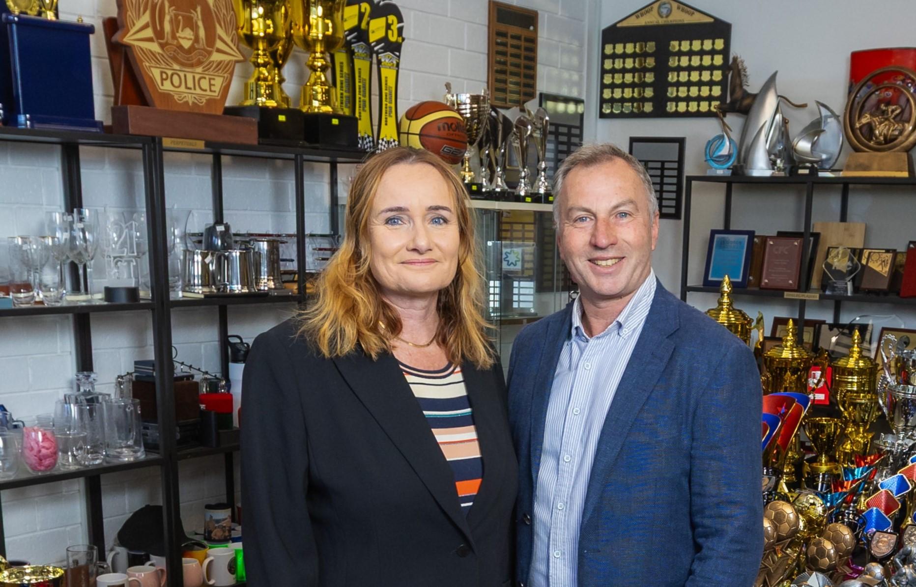 Image showing the two directors of Prime Trophies, Katya and Craigie Price, standing in their shop.