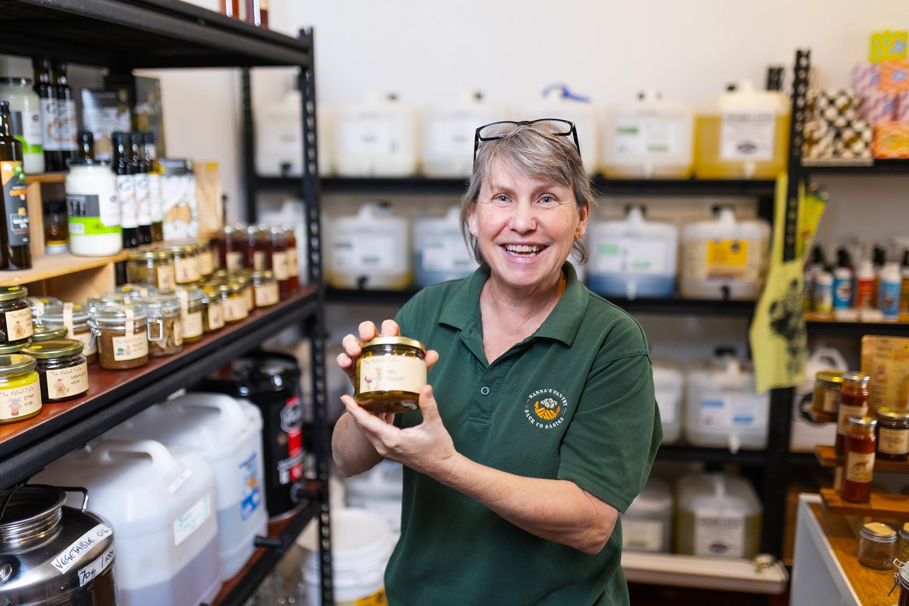 Photo of Claire Sly holding a product in her business, Nanna's Pantry.
