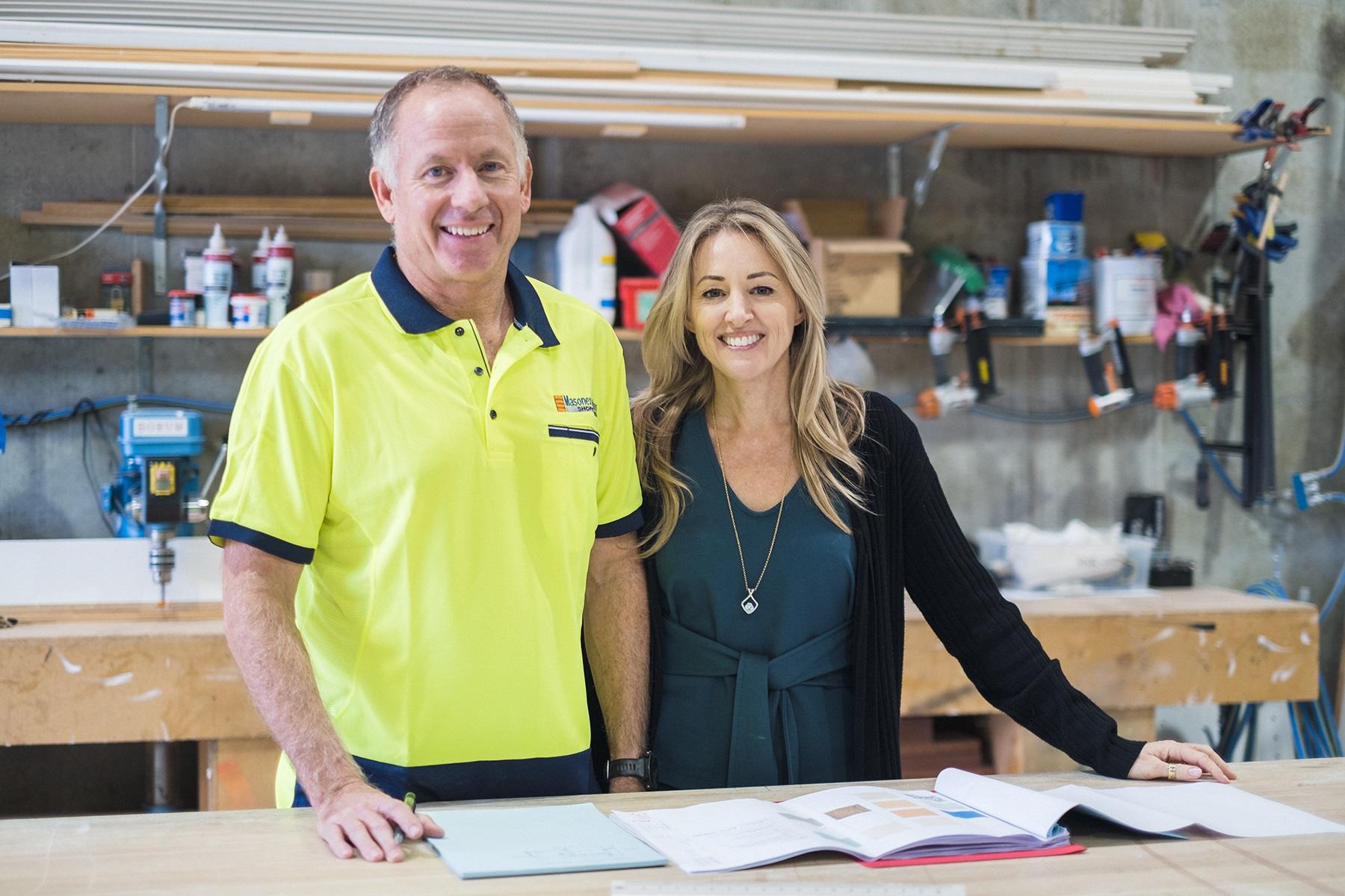 A photo of a male and female standing in their construction facility.