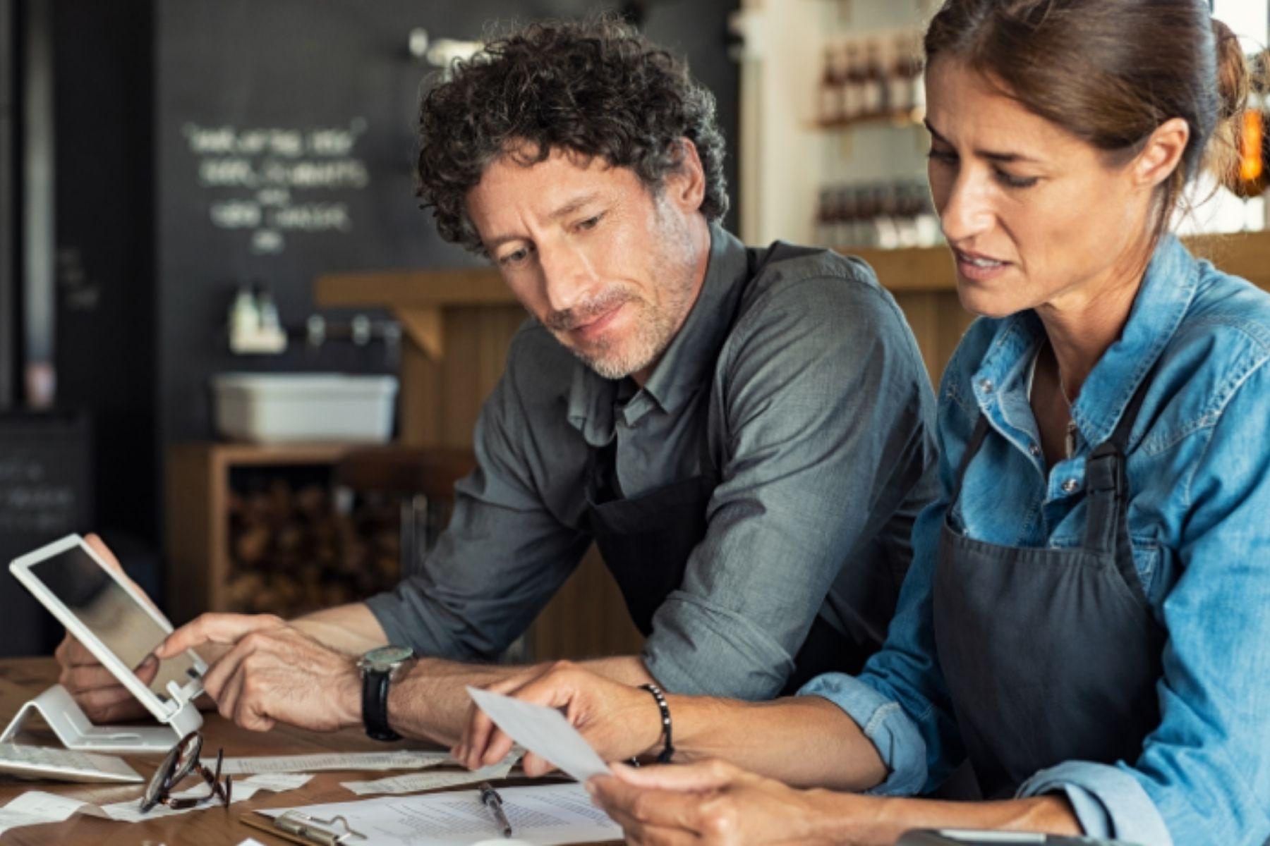 Photo of a man and a woman reviewing business documentation.