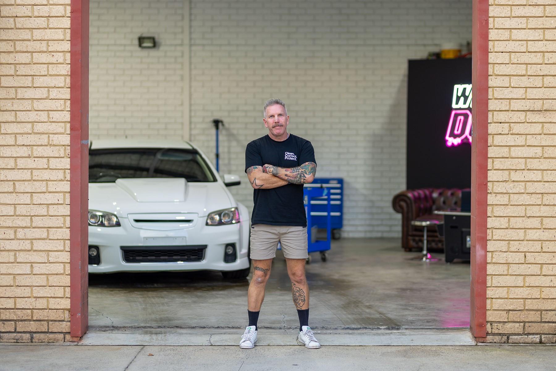 Photo of Paul Belczowski, owner of Diamond Detailing, standing at the entrance of his business premises.