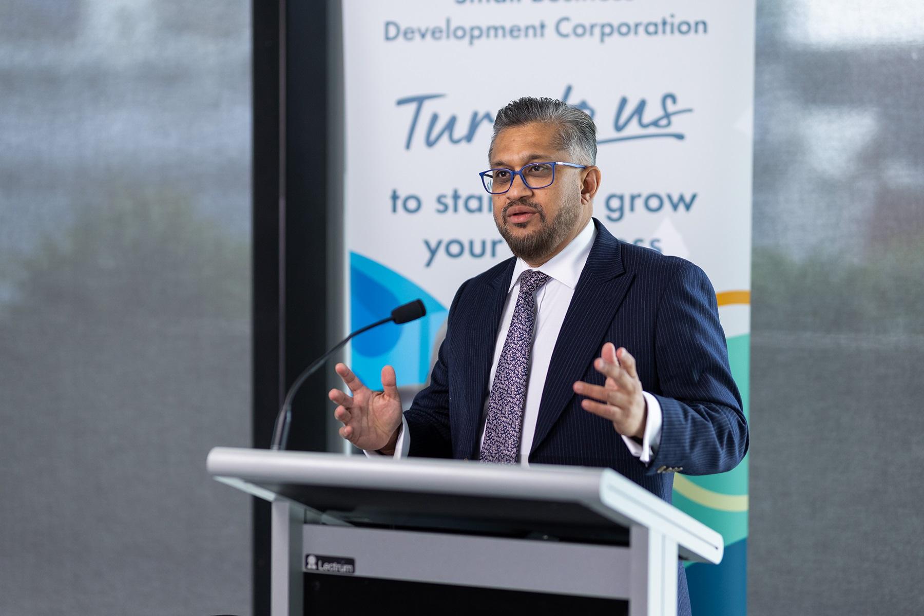 Photo of Saj Abdoolakhan, the Small Business Commissioner of Western Australia and CEO of the SBDC, speaking at an event.