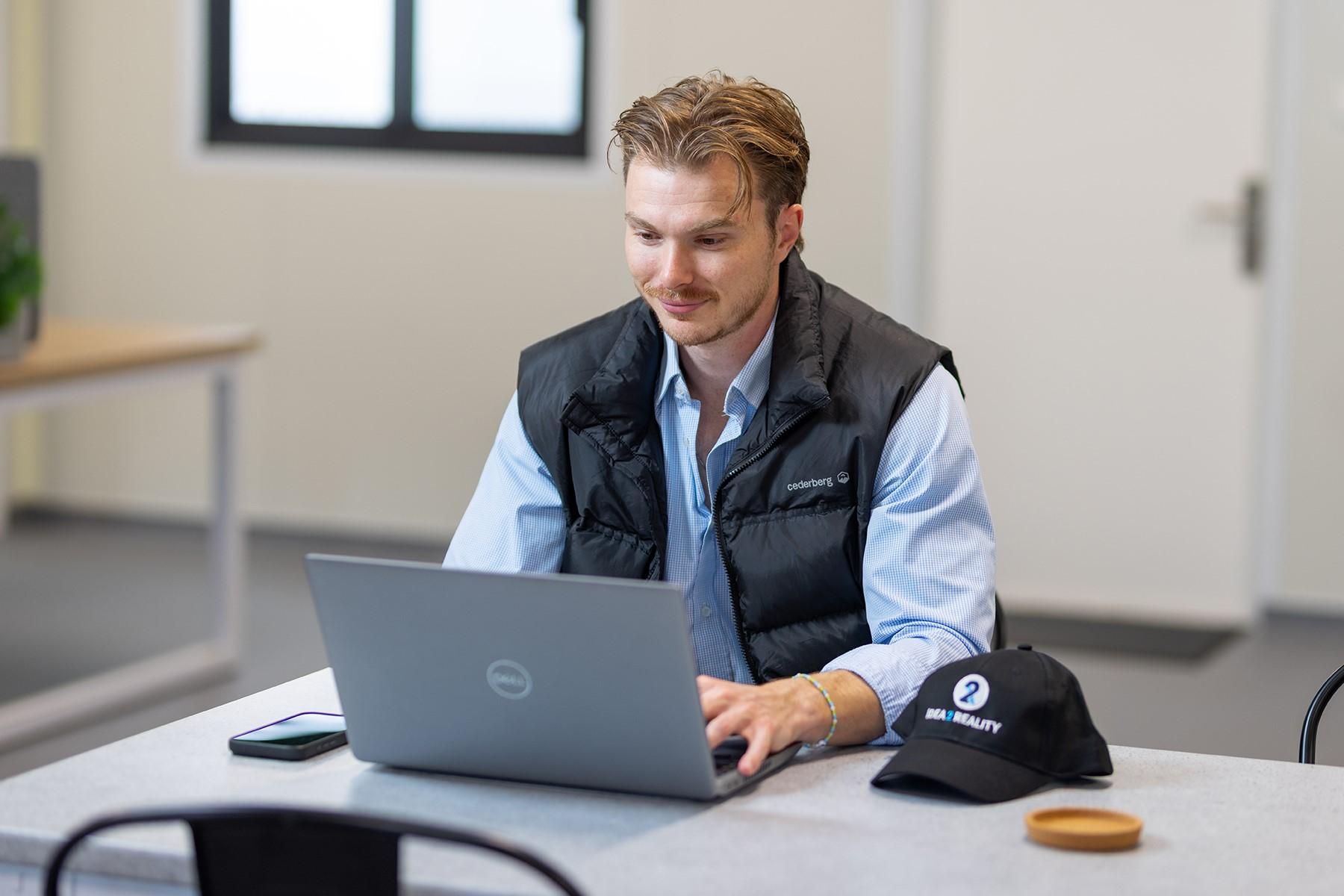 A man working on a laptop.