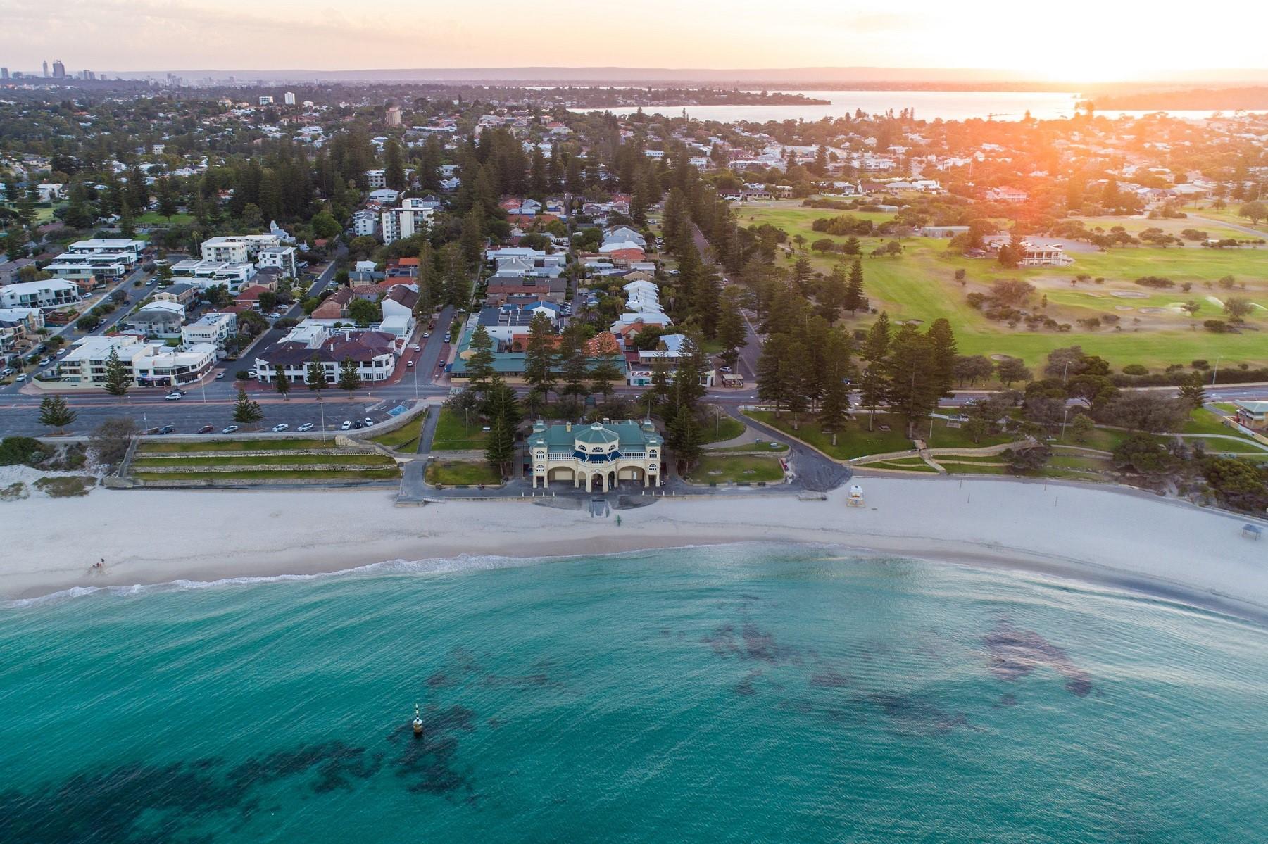 Aerial photo of Cottesloe beach with the Swan River in the background.