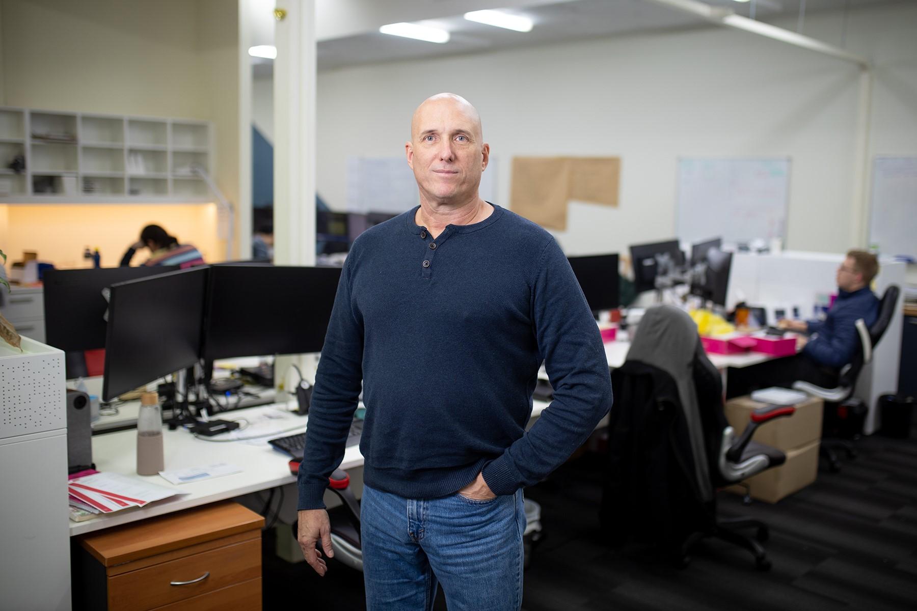 Photo of a man standing in an office.