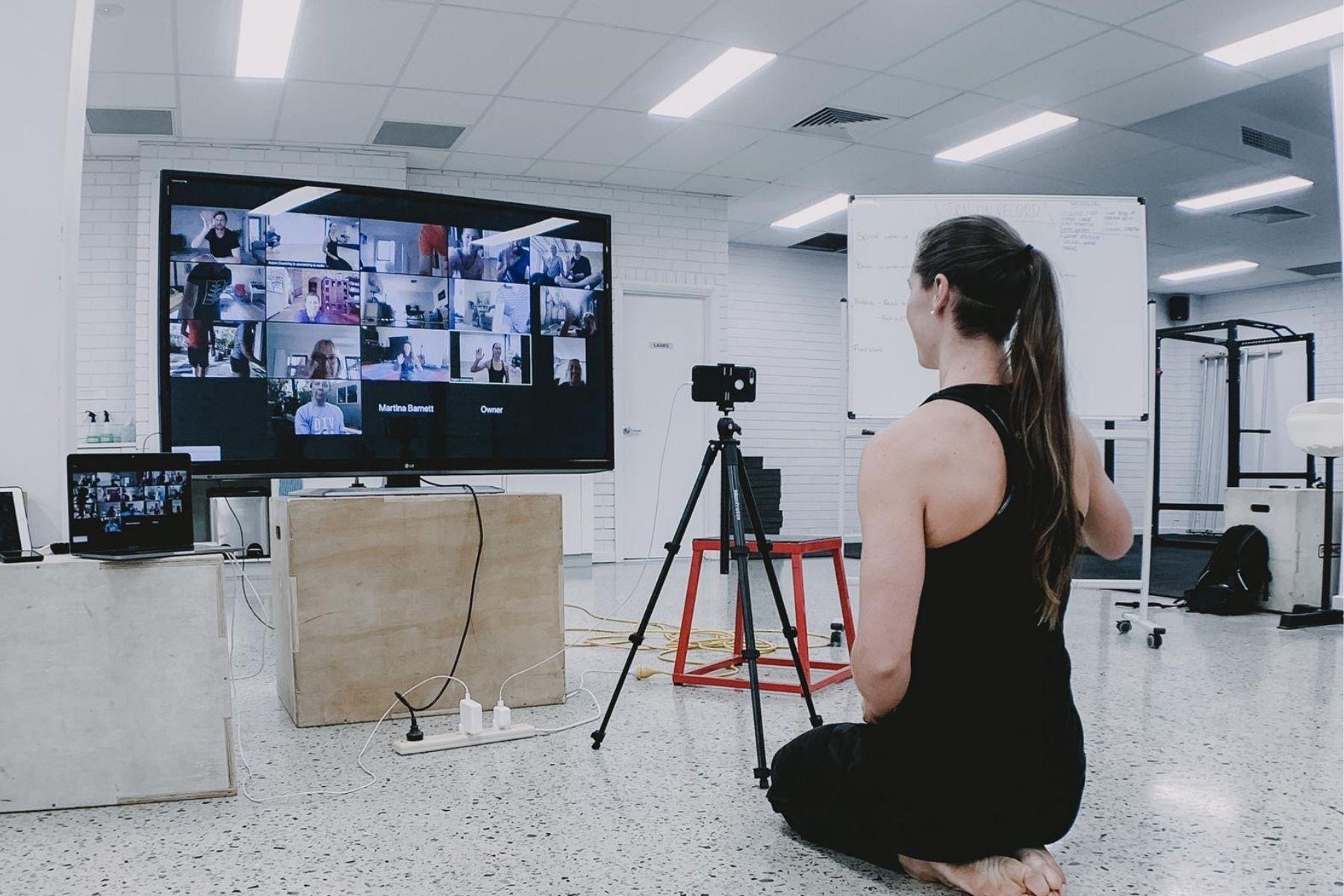 Image of a lady conducting a zoom lesson in front of a camera