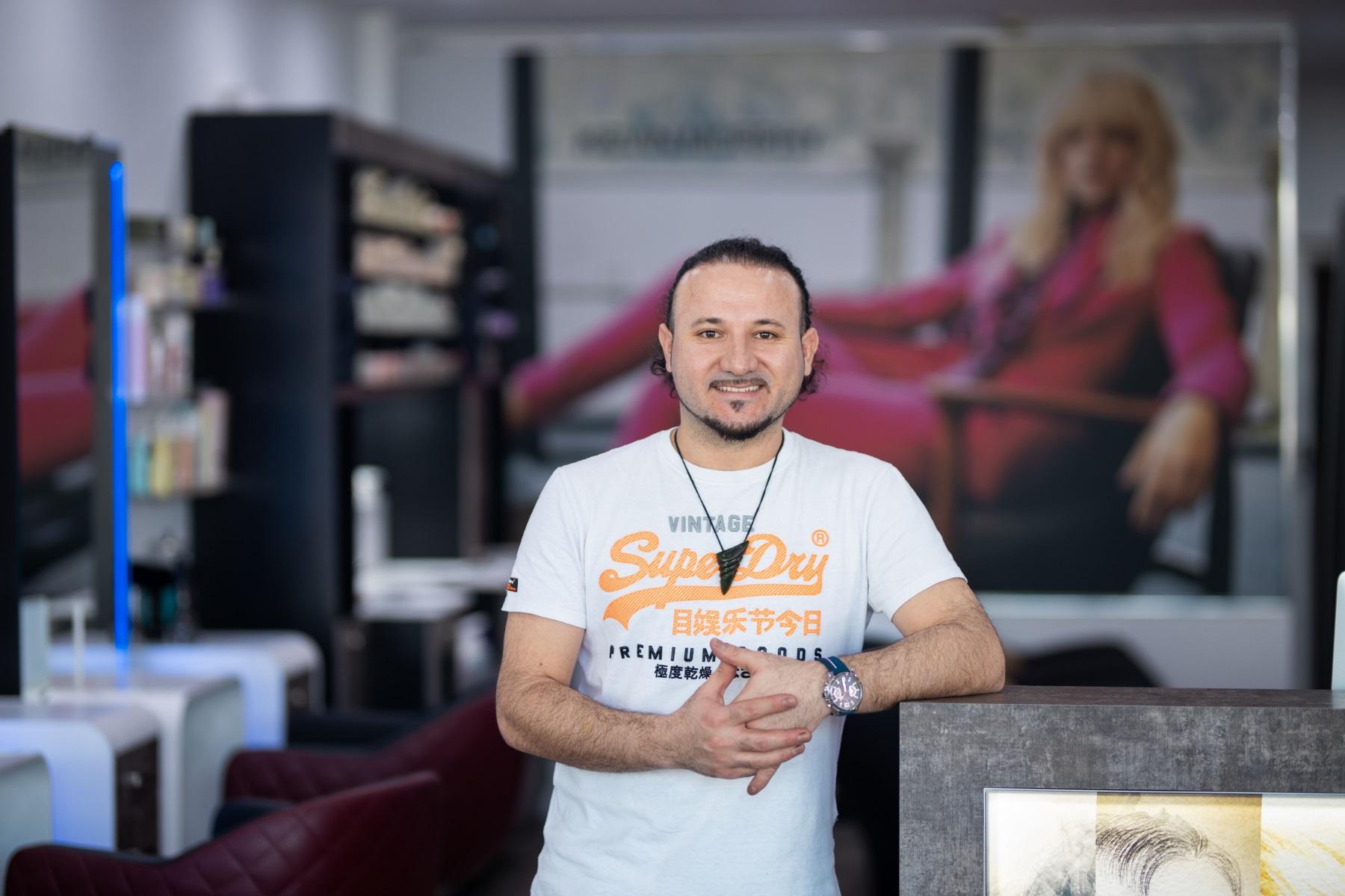 Photo of a man standing in a hair salon.