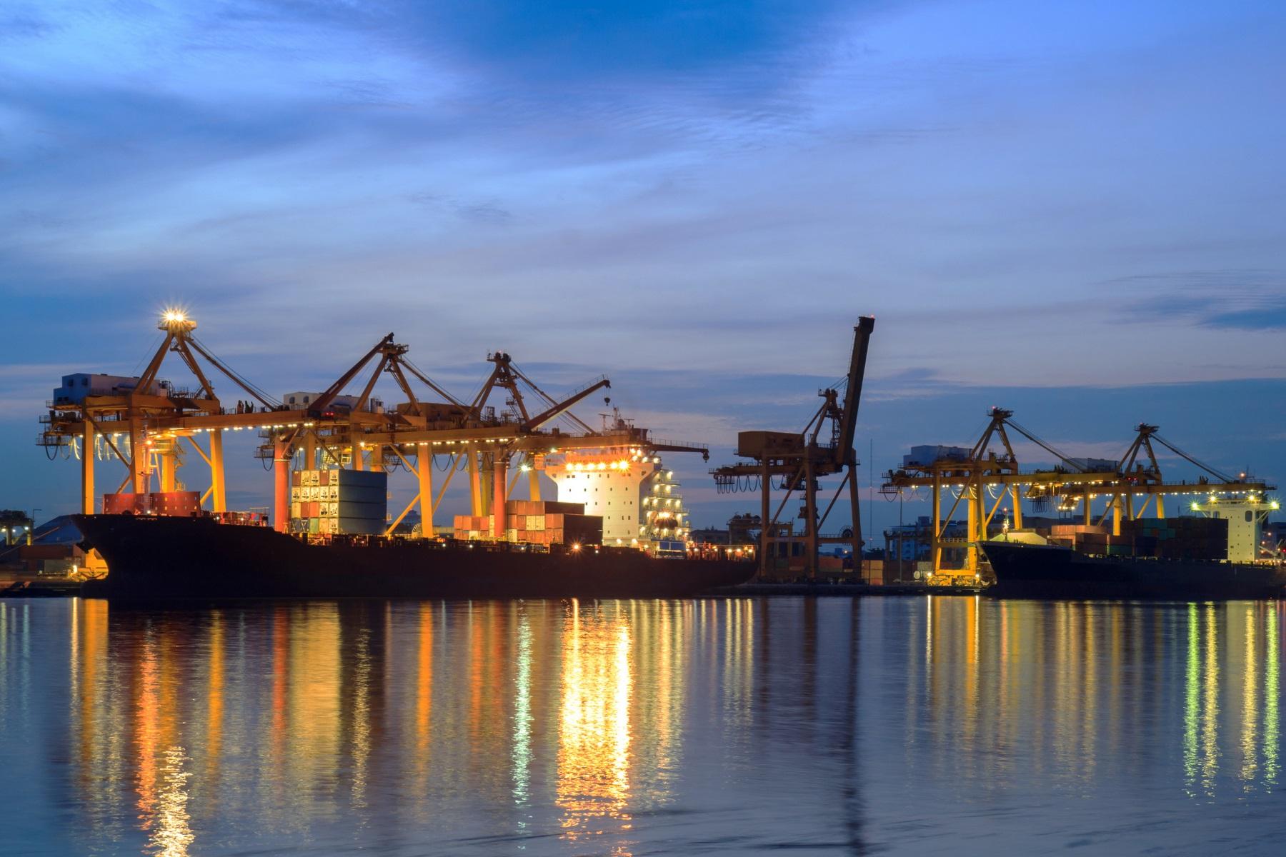 Image of a Port with shipping containers and cargo vessels.