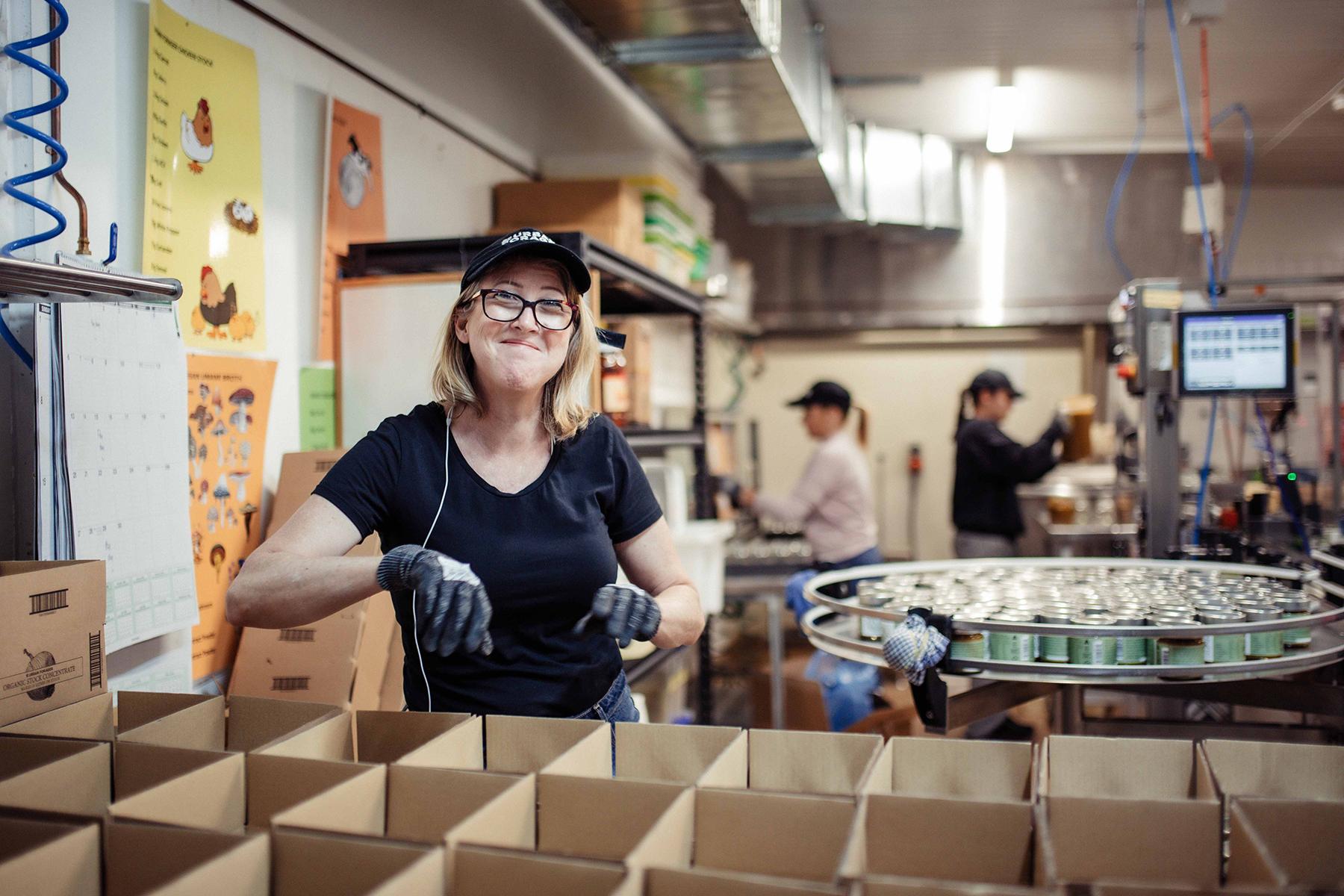 Photo of Lou Corteen, owner of Urban Forager, standing in her production kitchen.