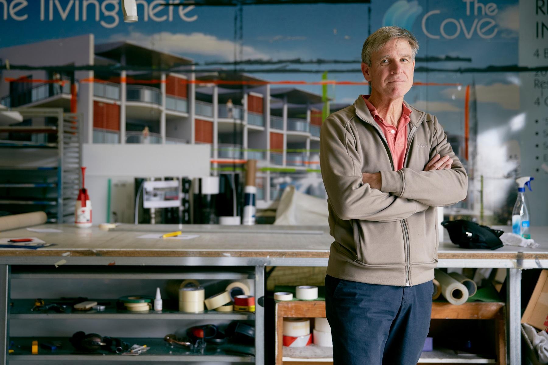 Photo of a man standing in a printing business.
