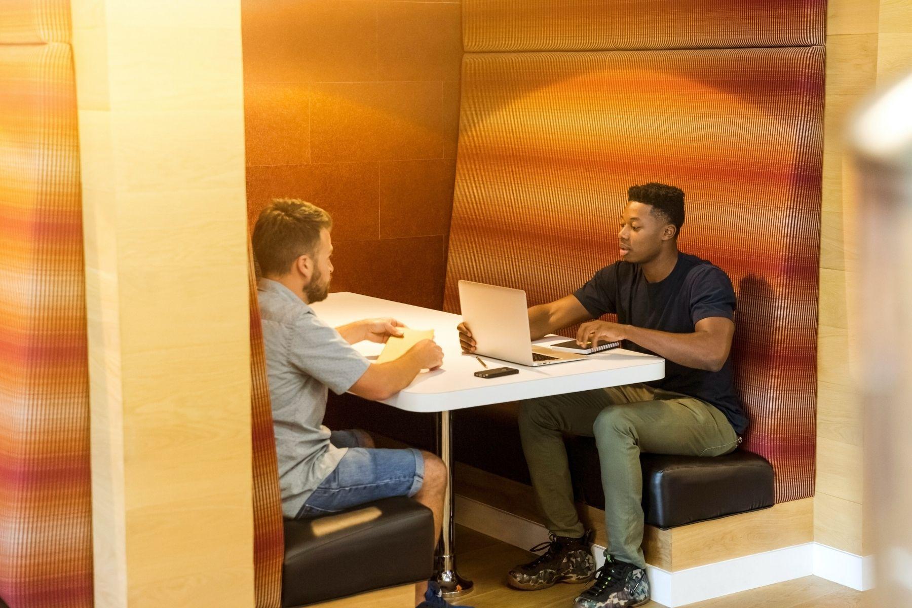 Photo of two men meeting in a co-working space.