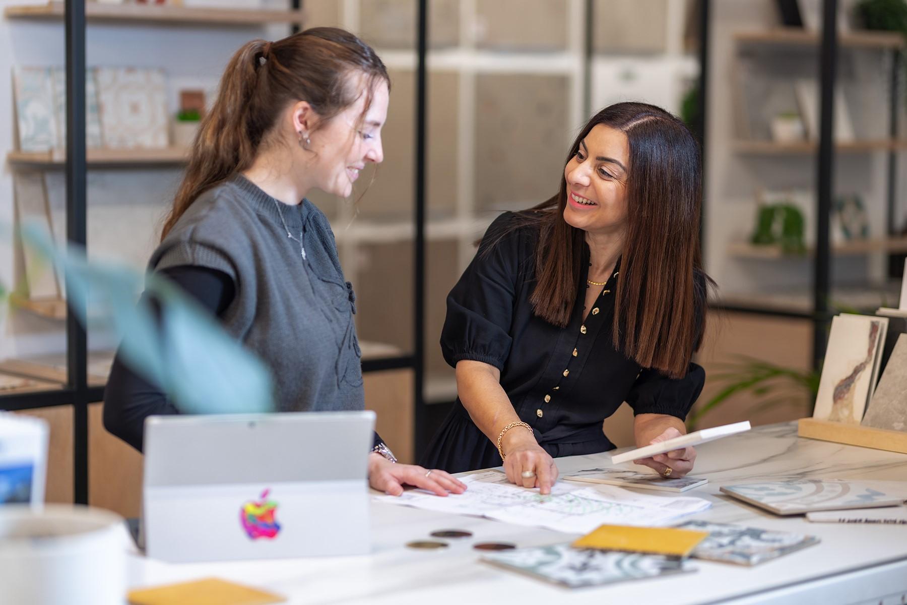 Photo of a woman talking to a female customer in her ceramics business.