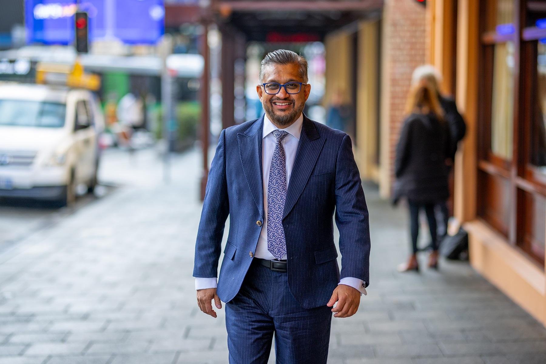 Photo of Small Business Commissioner and SBDC CEO Saj Abdoolakhan walking down William Street in the Perth CBD.