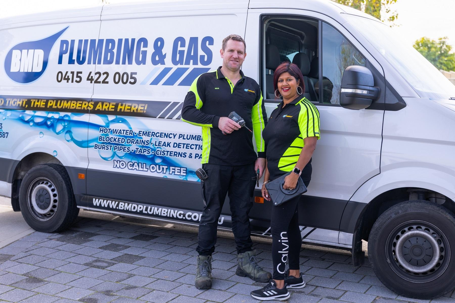 Photo of Brian and Tiana McDaid standing in front of a BMD Plumbing and Gas branded work van.