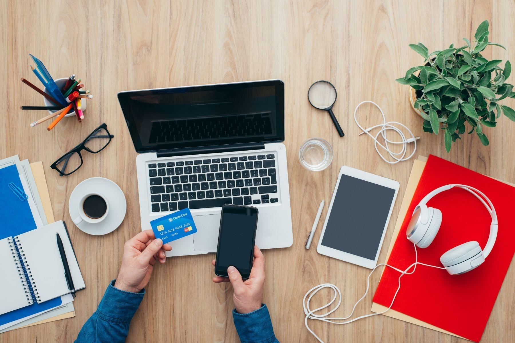 Photo of a person paying for an online purchase with a credit card.