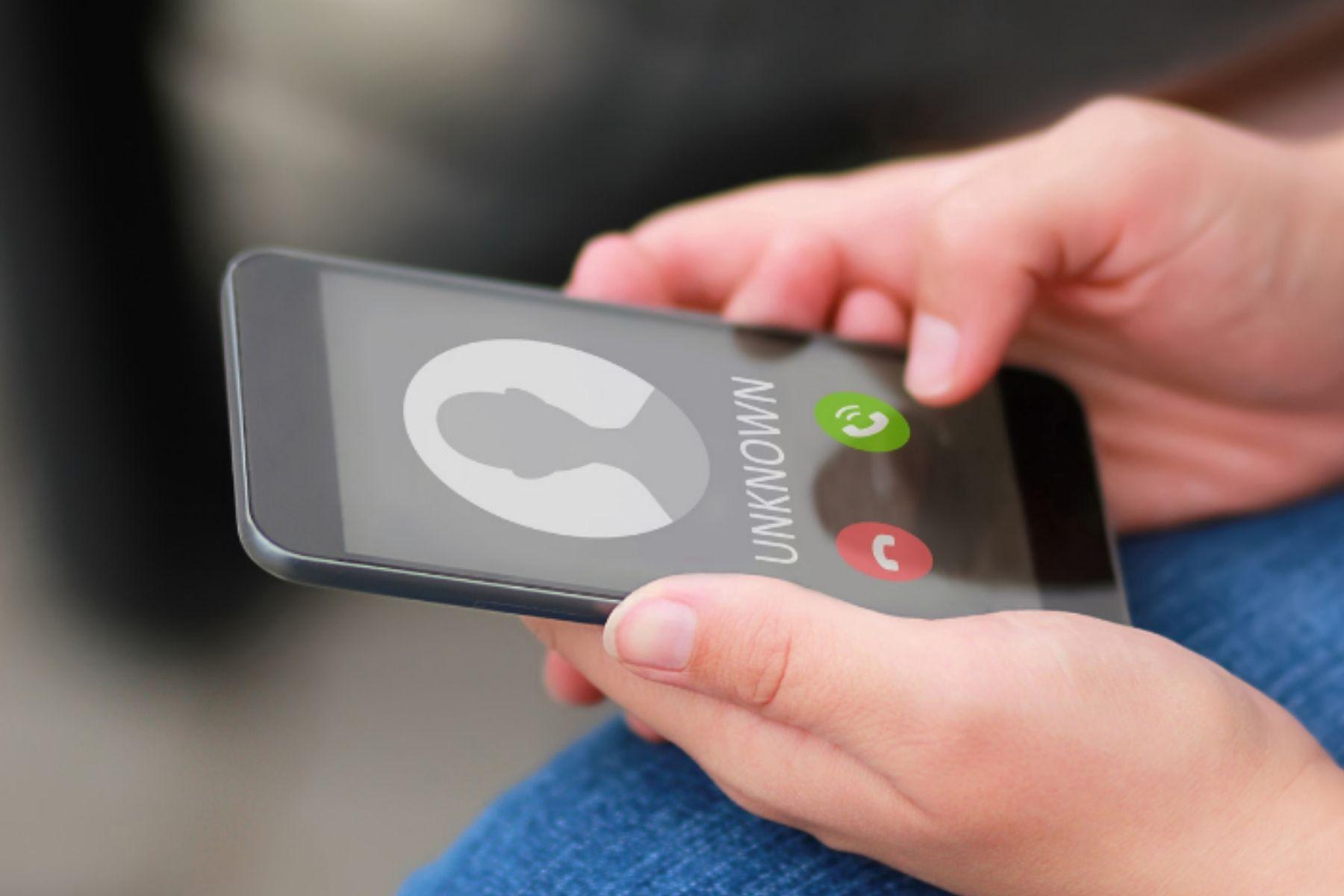 Photo of a smartphone showing an incoming call from an unknown caller.