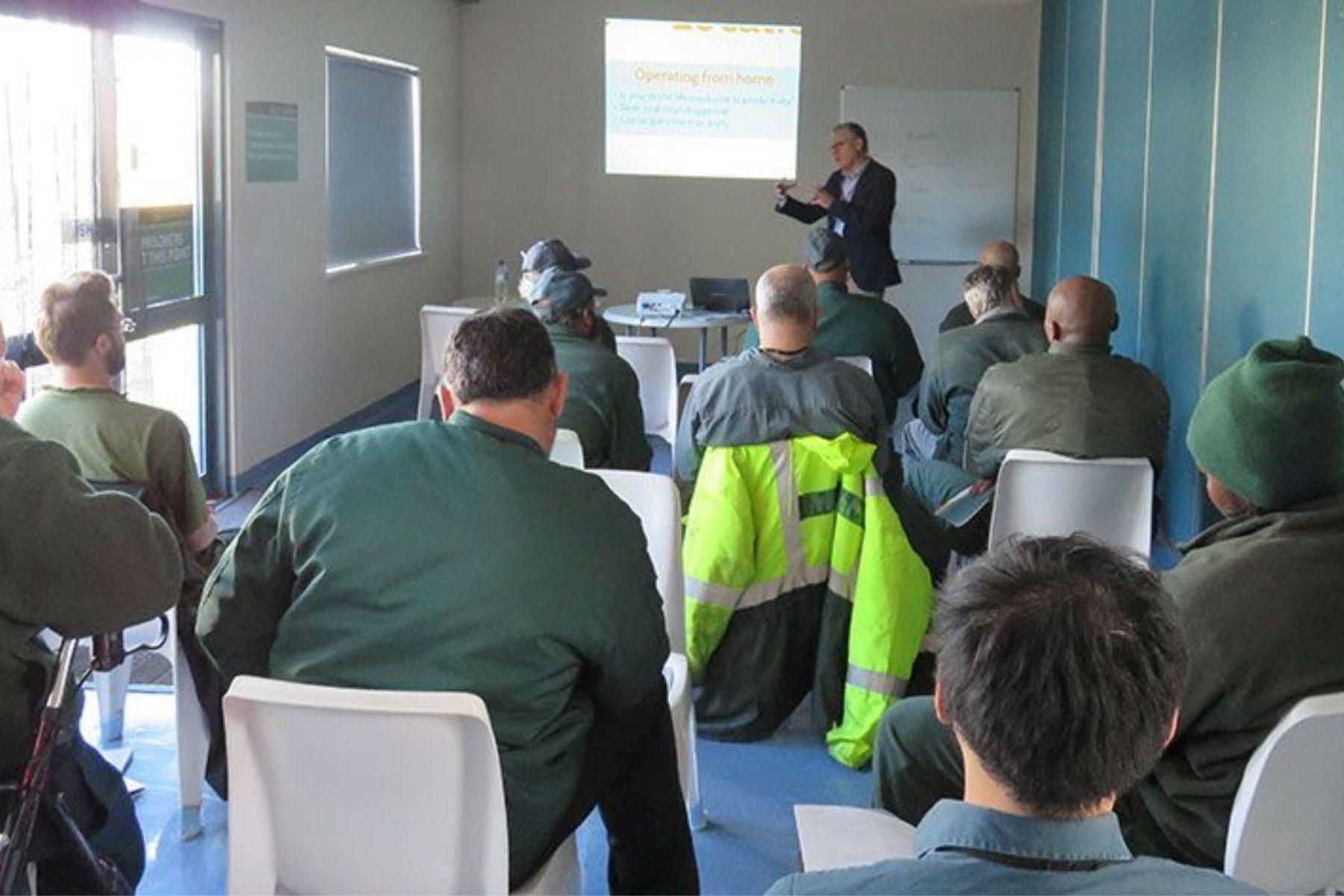 Photo of an SBDC staff member presenting a business skills workshop to in a prison.