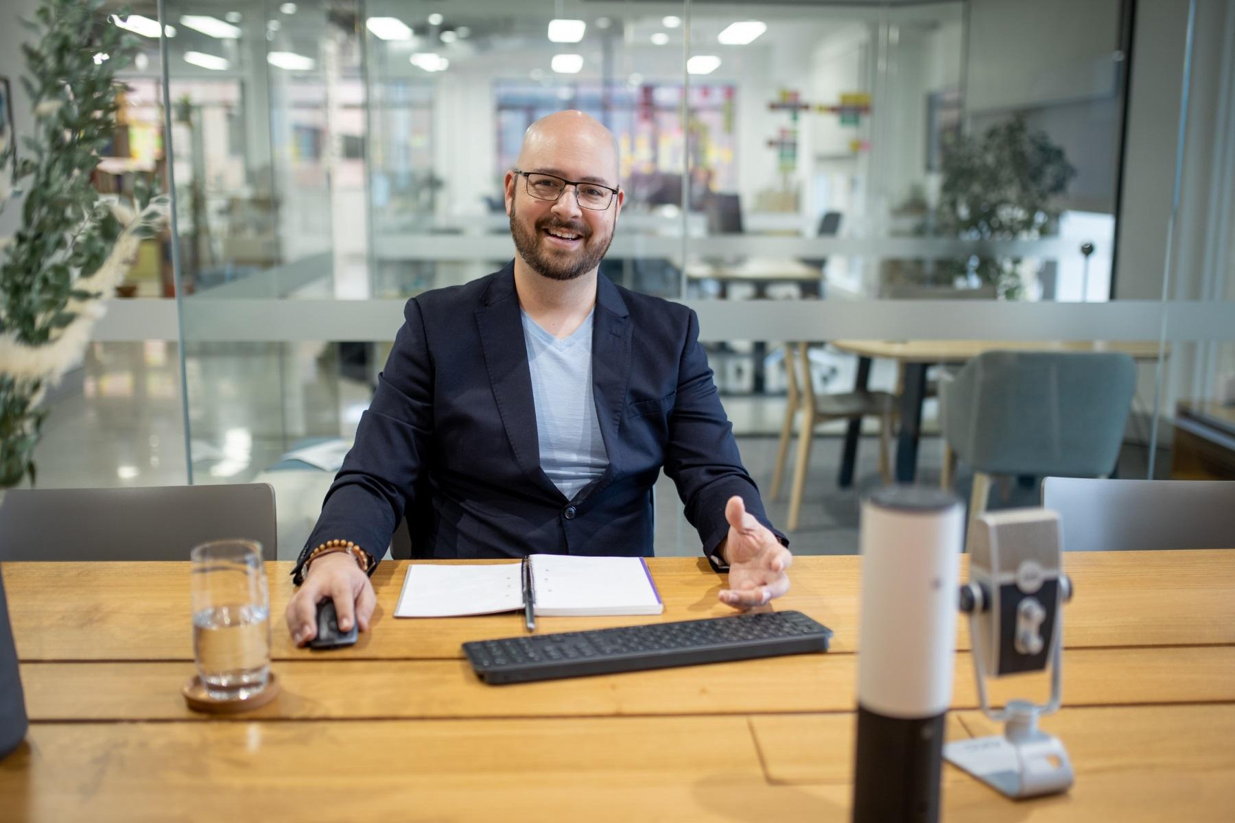 Photo of a man presenting in a meeting room.