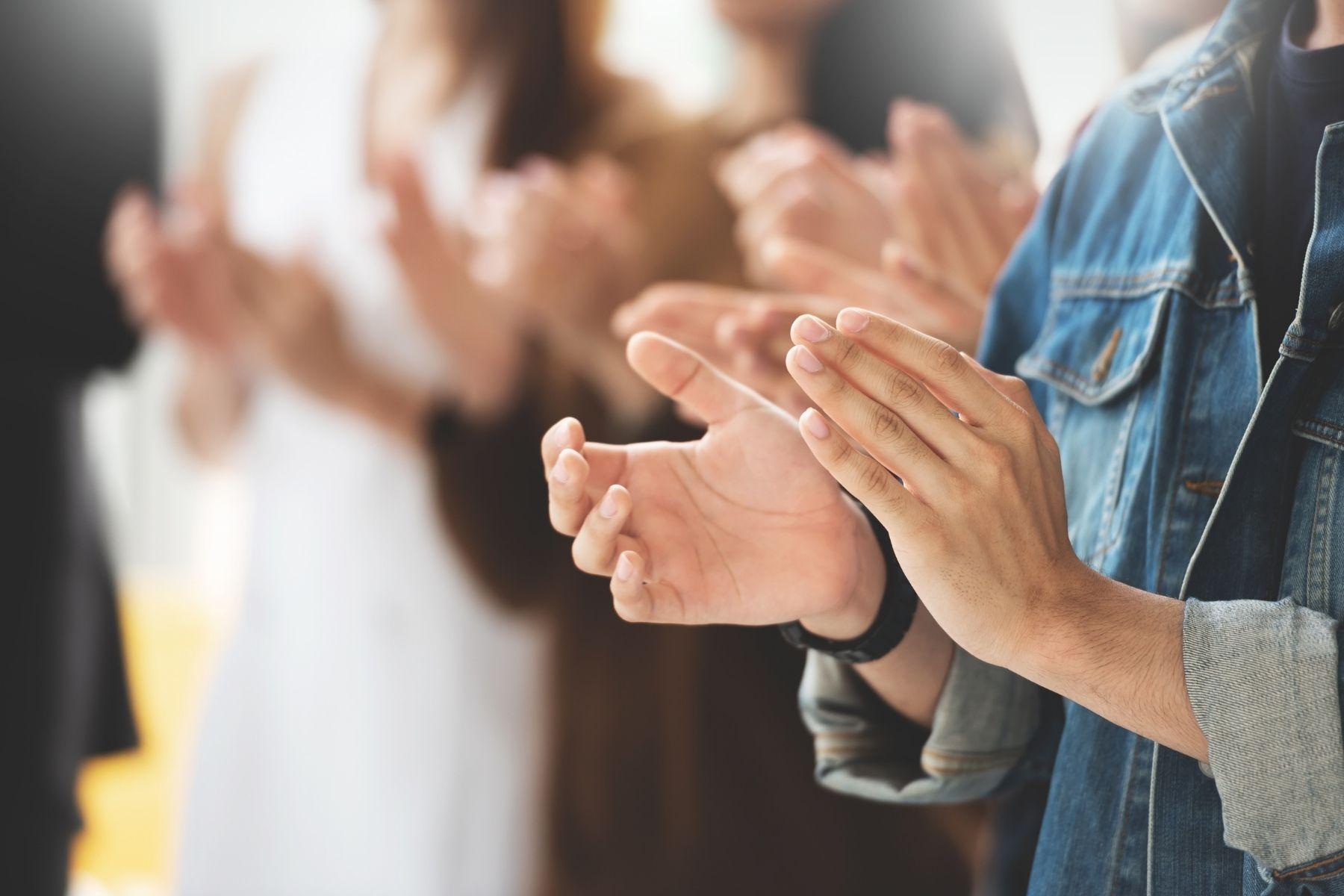 Photo of hands applauding.