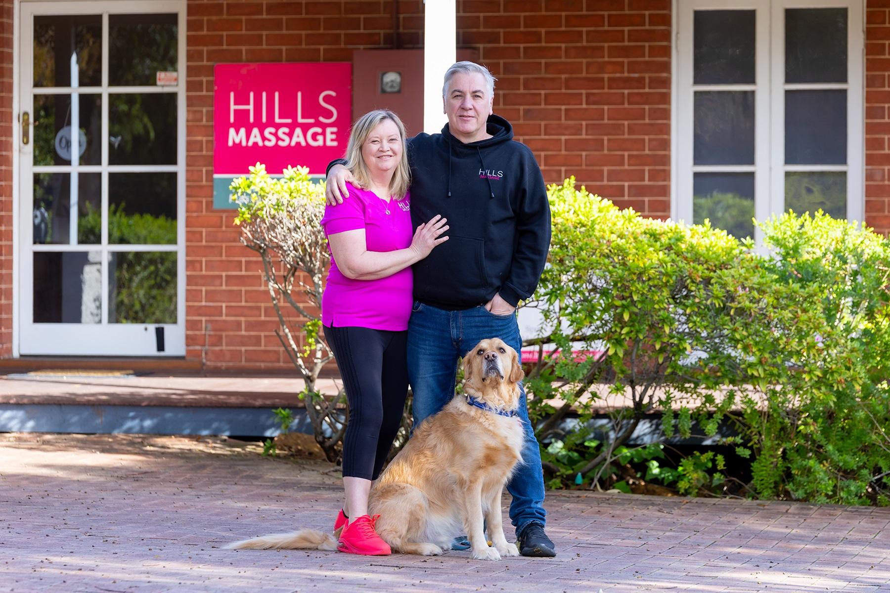 Photo of Michelle Rimmer and her husband, Alec, outside of their business Hills Massage.