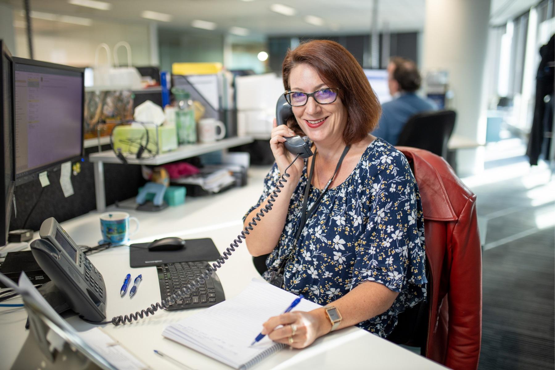 Photo of an SBDC staff member providing assistance over the phone.