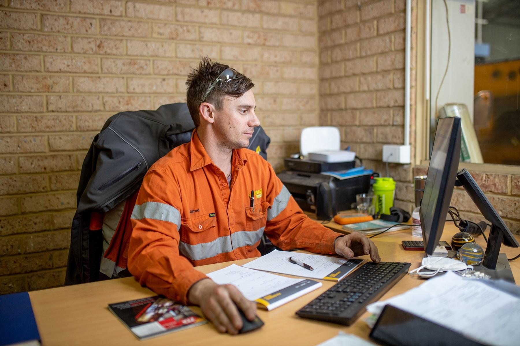 Photo of a male business owner working at a computer.