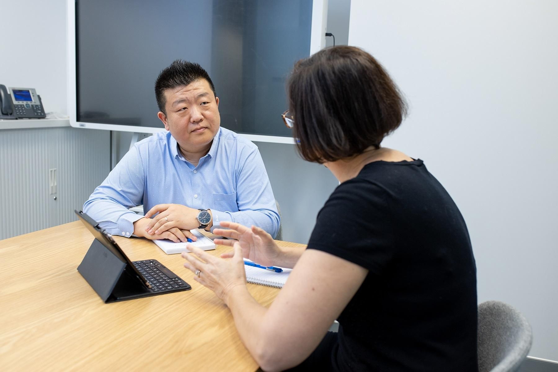 A photo of a man and woman having a discussion.