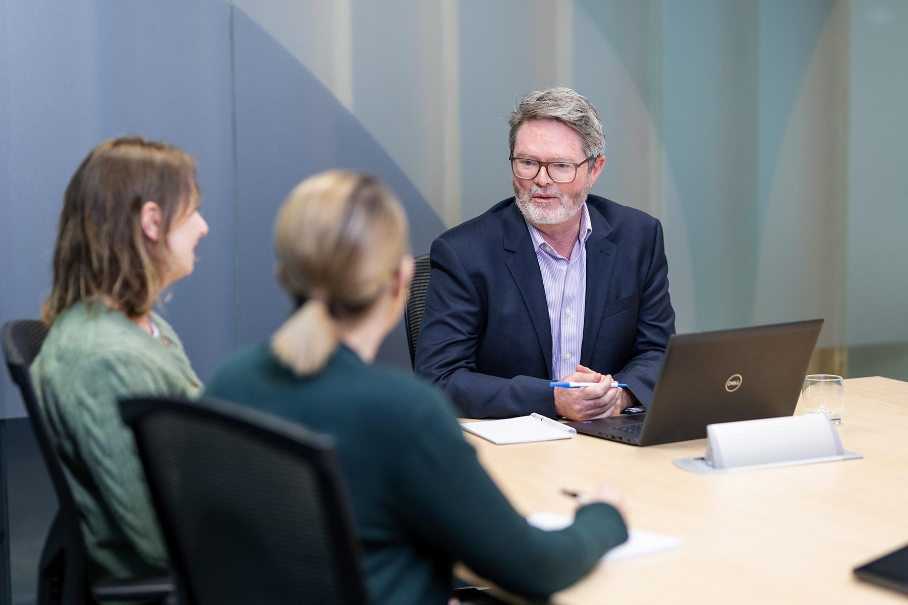 Photo of an SBDC business adviser talking to clients.