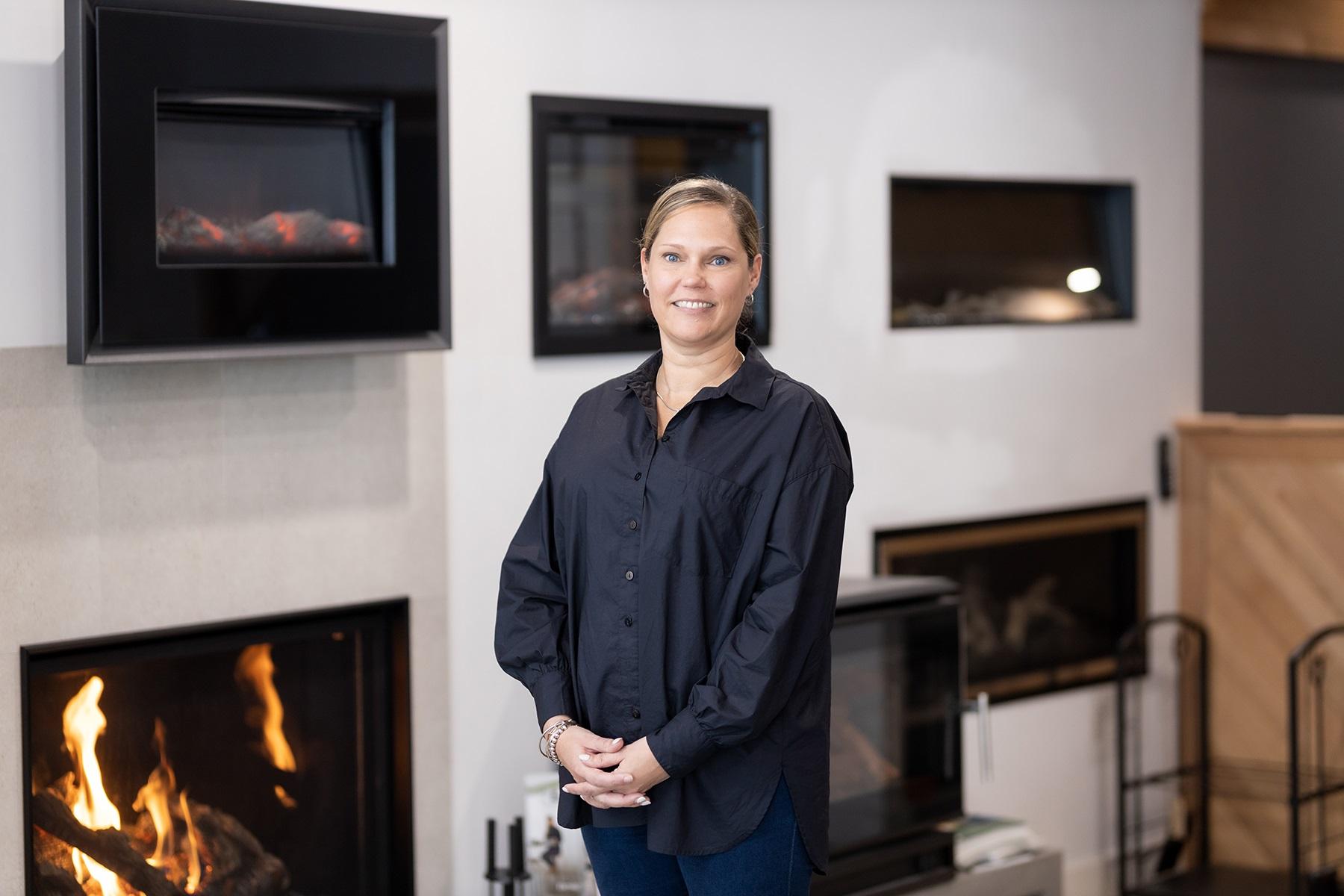 Photo of Jasmine Kik, owner of Fireplaces WA, standing in her Perth showroom.
