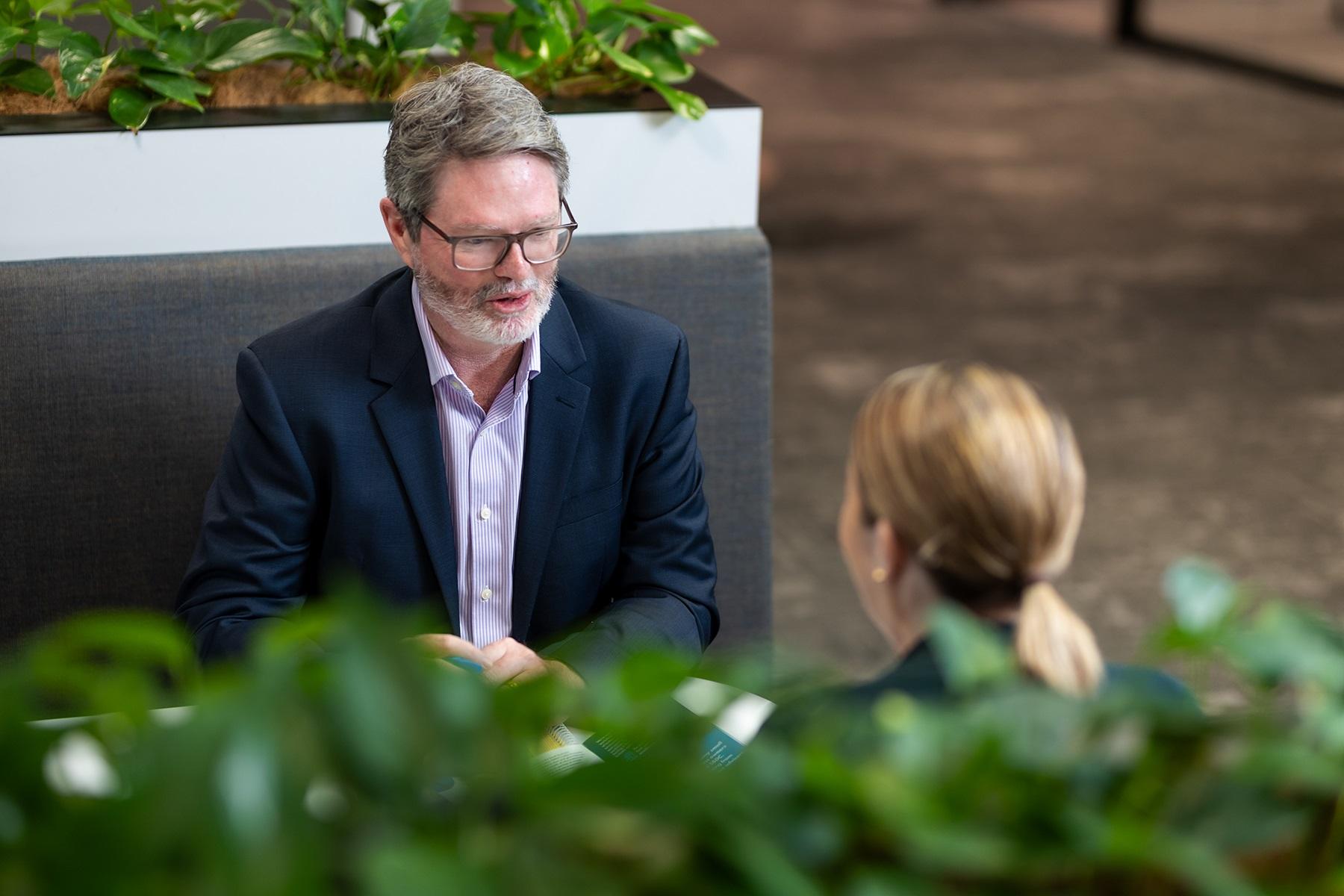 Photo of a man and a woman having a conversation.